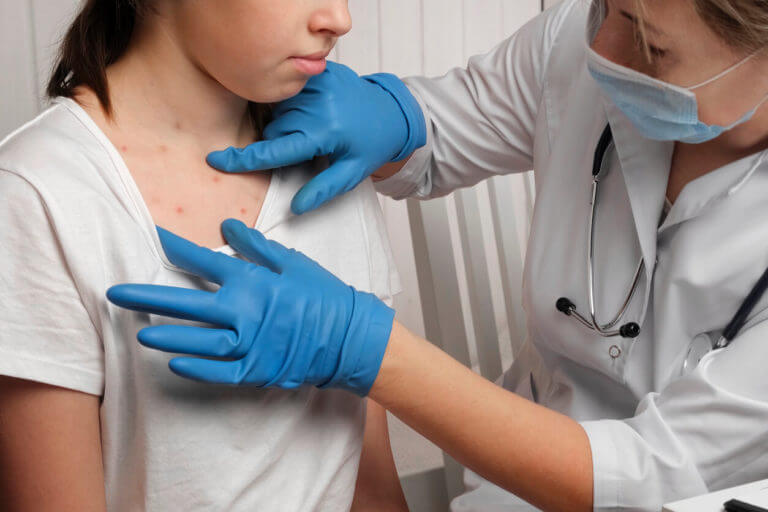 pediatric doctor checking the patient skin for eczema