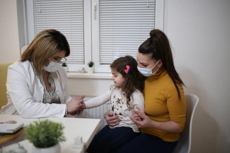 Little girl having medical examination by dermatologist